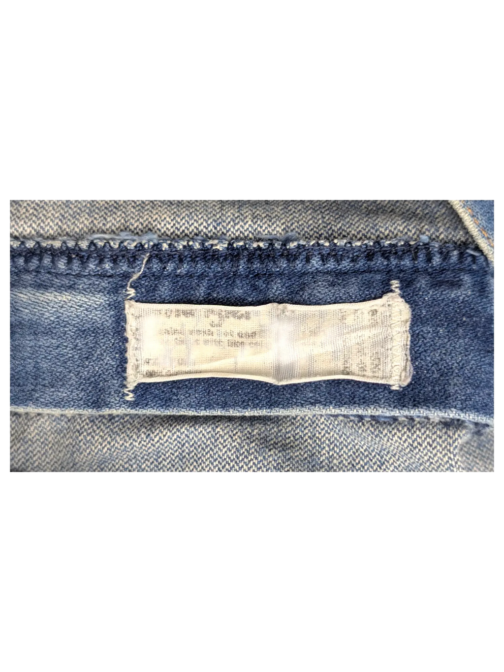 JAKE & IPI Wrangler bootcut jeans featuring a close-up view of the interior denim fabric care label and stitching.