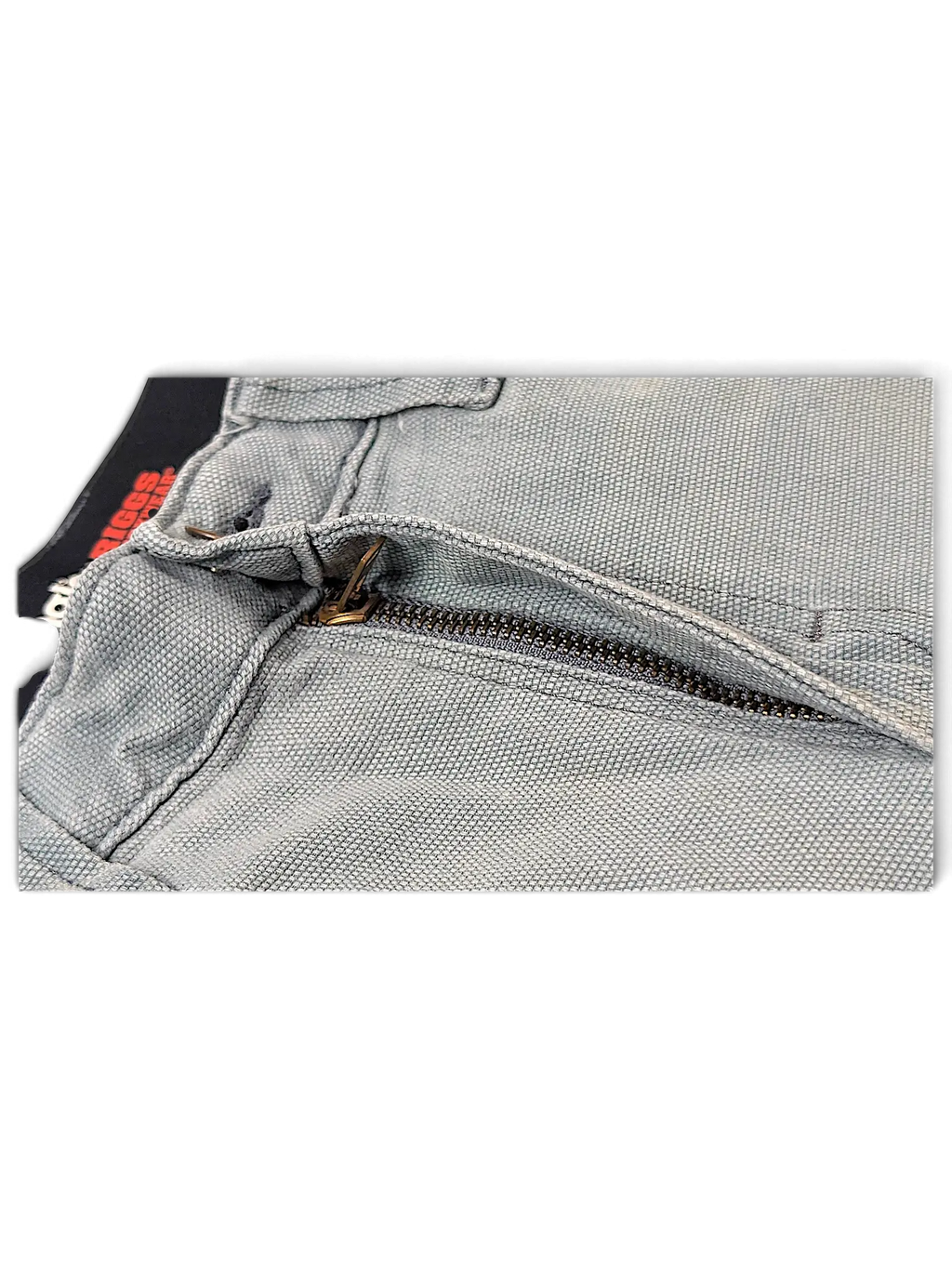 Close-up of JAKE & IPI Wrangler Riggs workwear pants in grey canvas with a durable metal zipper fly.