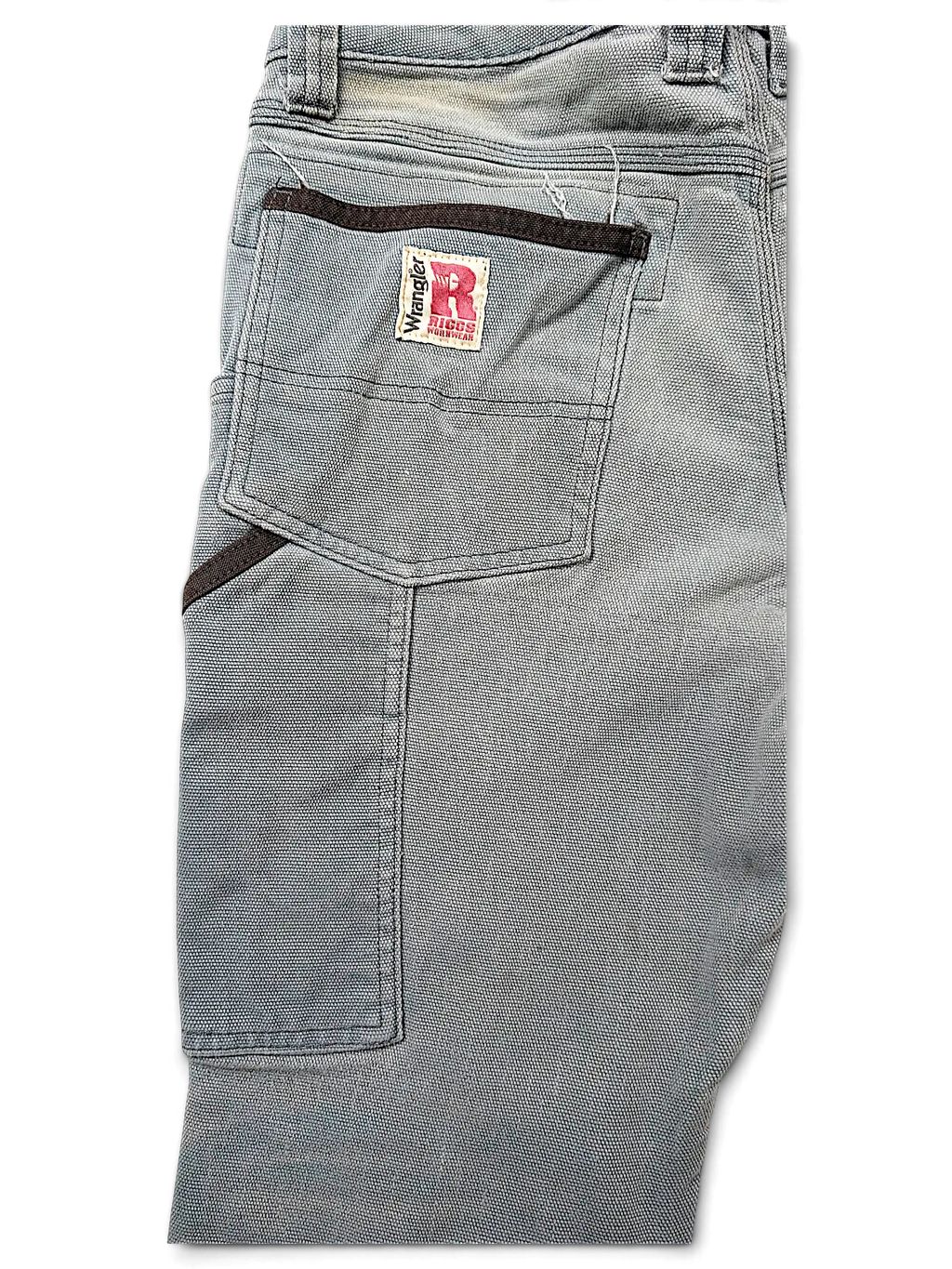 JAKE & IPI Wrangler Riggs Workwear pants in grey canvas with reinforced back pockets and brown trim details.
