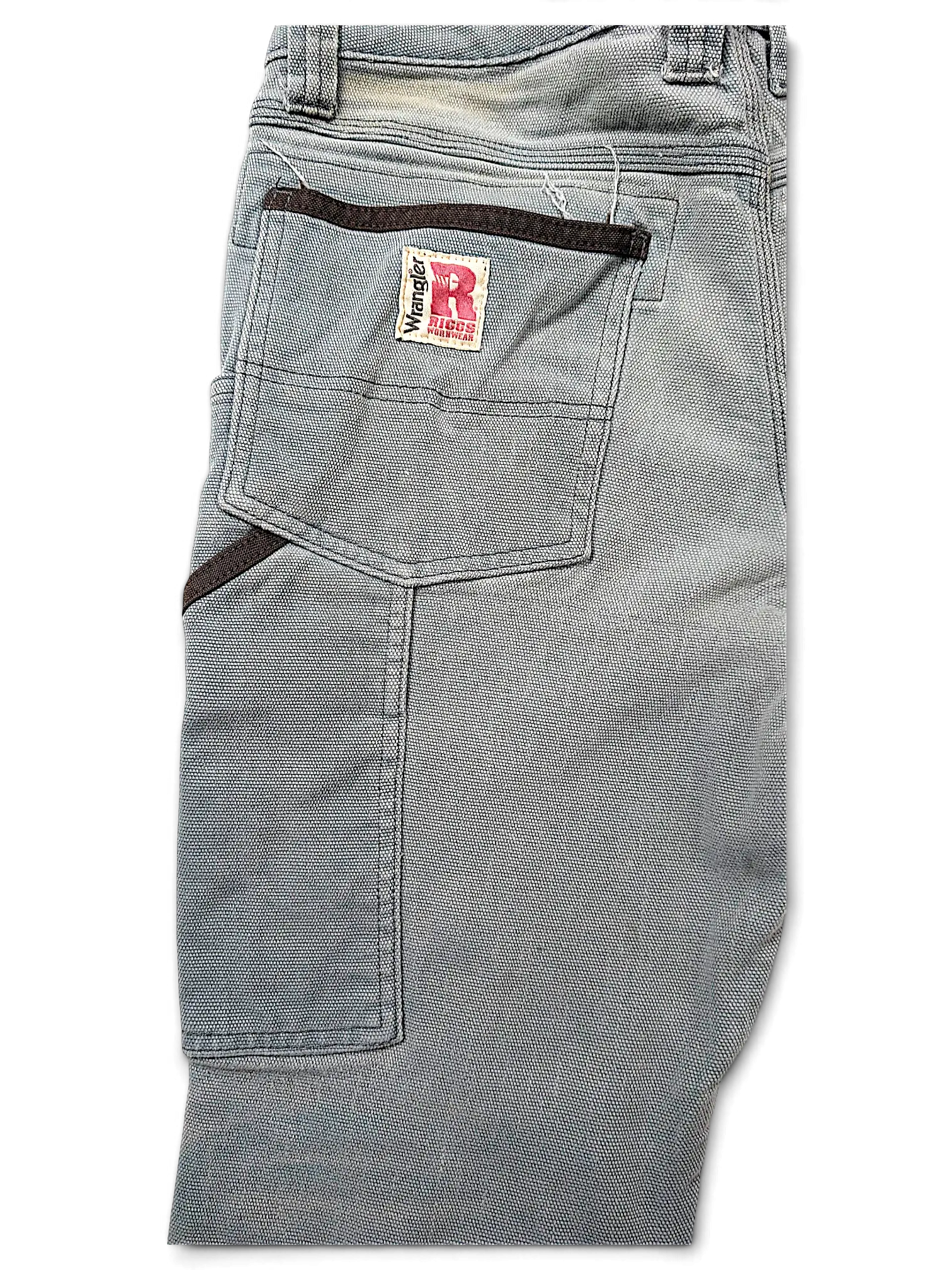 JAKE & IPI Wrangler Riggs Workwear pants in grey canvas with reinforced back pockets and brown trim details.