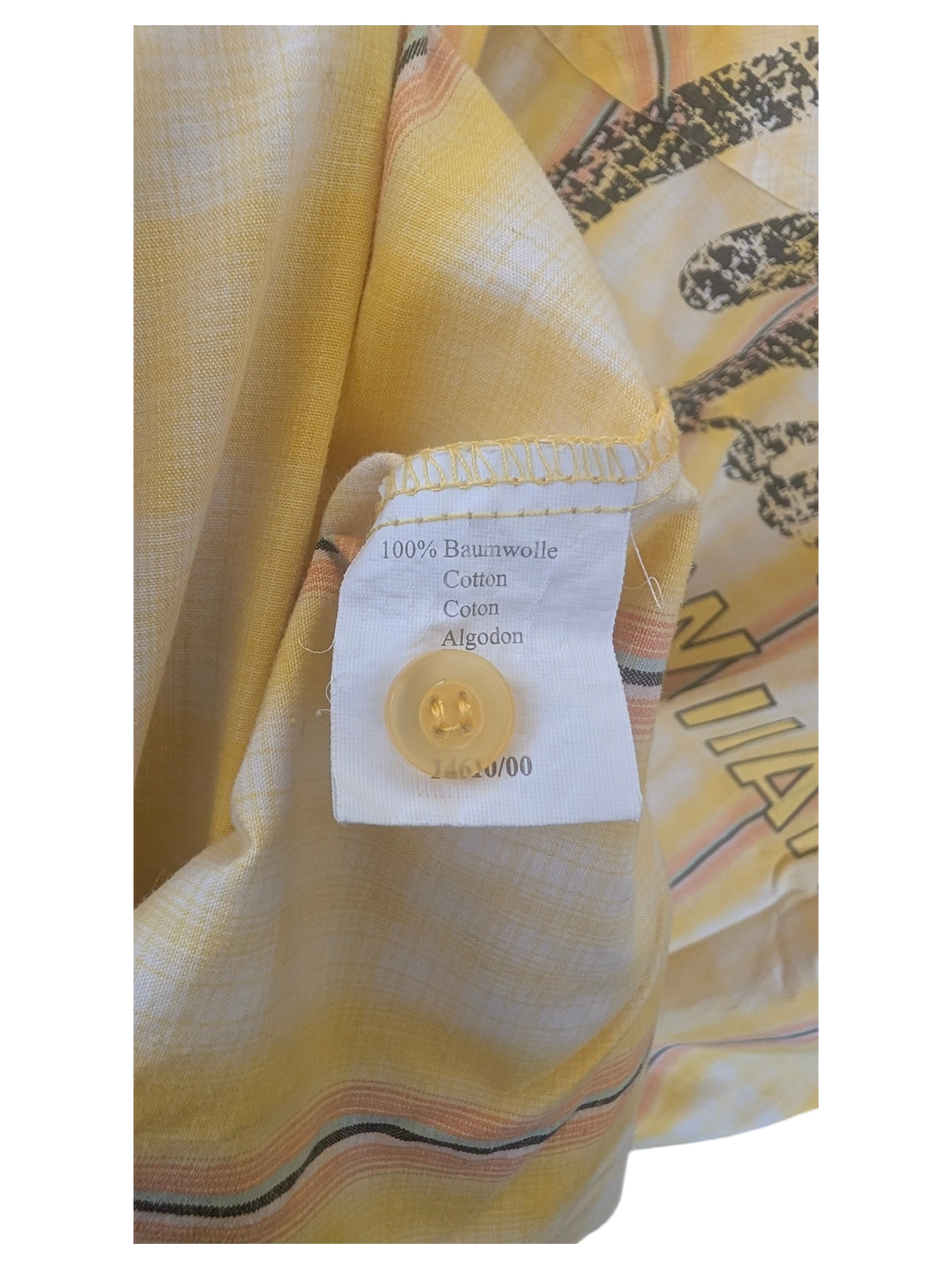 JAKE & IPI yellow Hawaiian shirt interior label showing 100% cotton material and matching yellow button