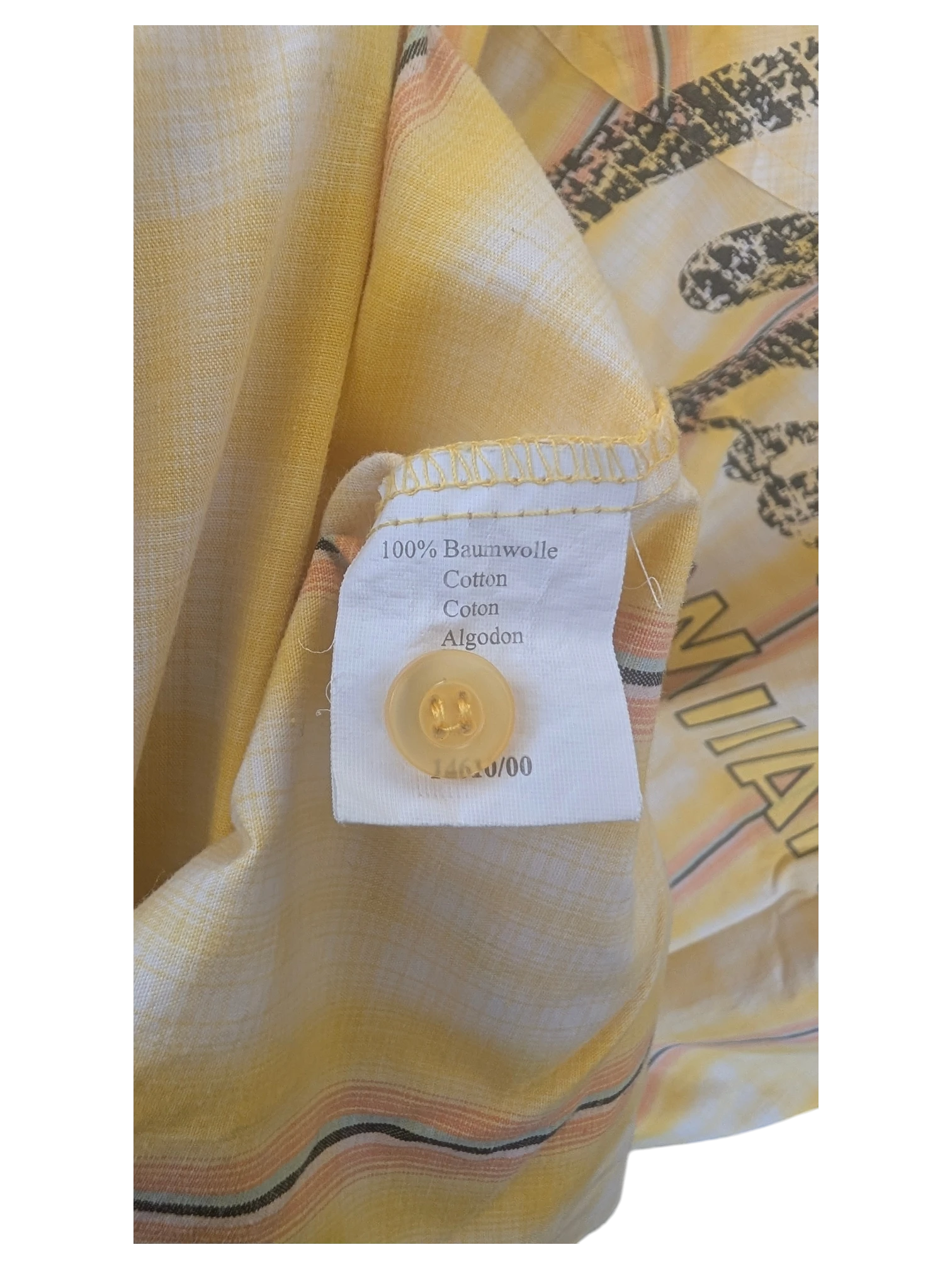 JAKE & IPI yellow Hawaiian shirt interior label showing 100% cotton material and matching yellow button