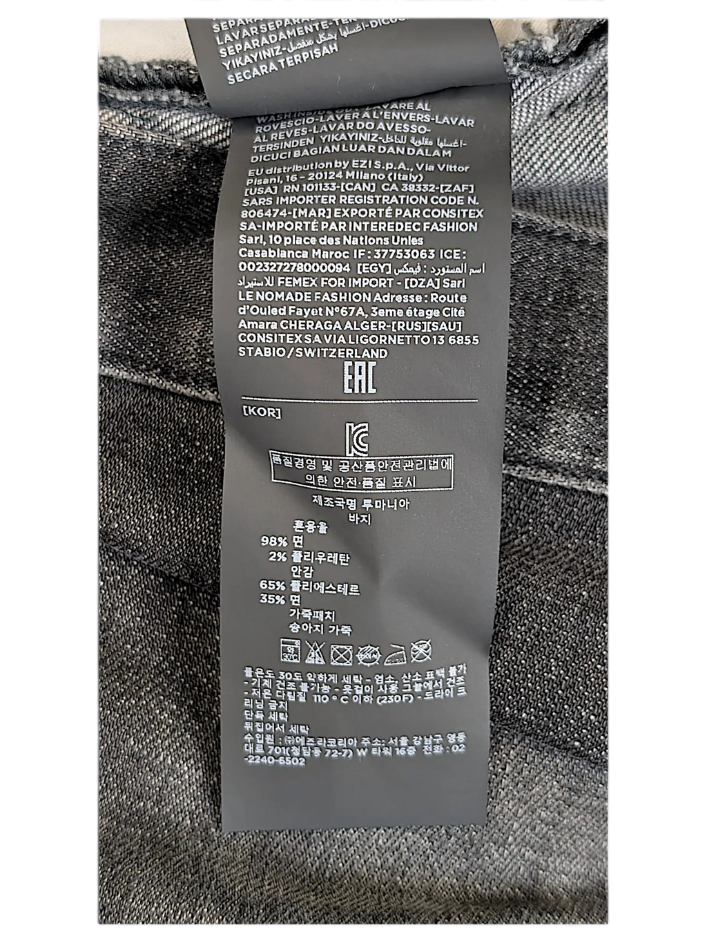 JAKE & IPI Zegna jeans interior care label with material composition and washing instructions in multiple languages