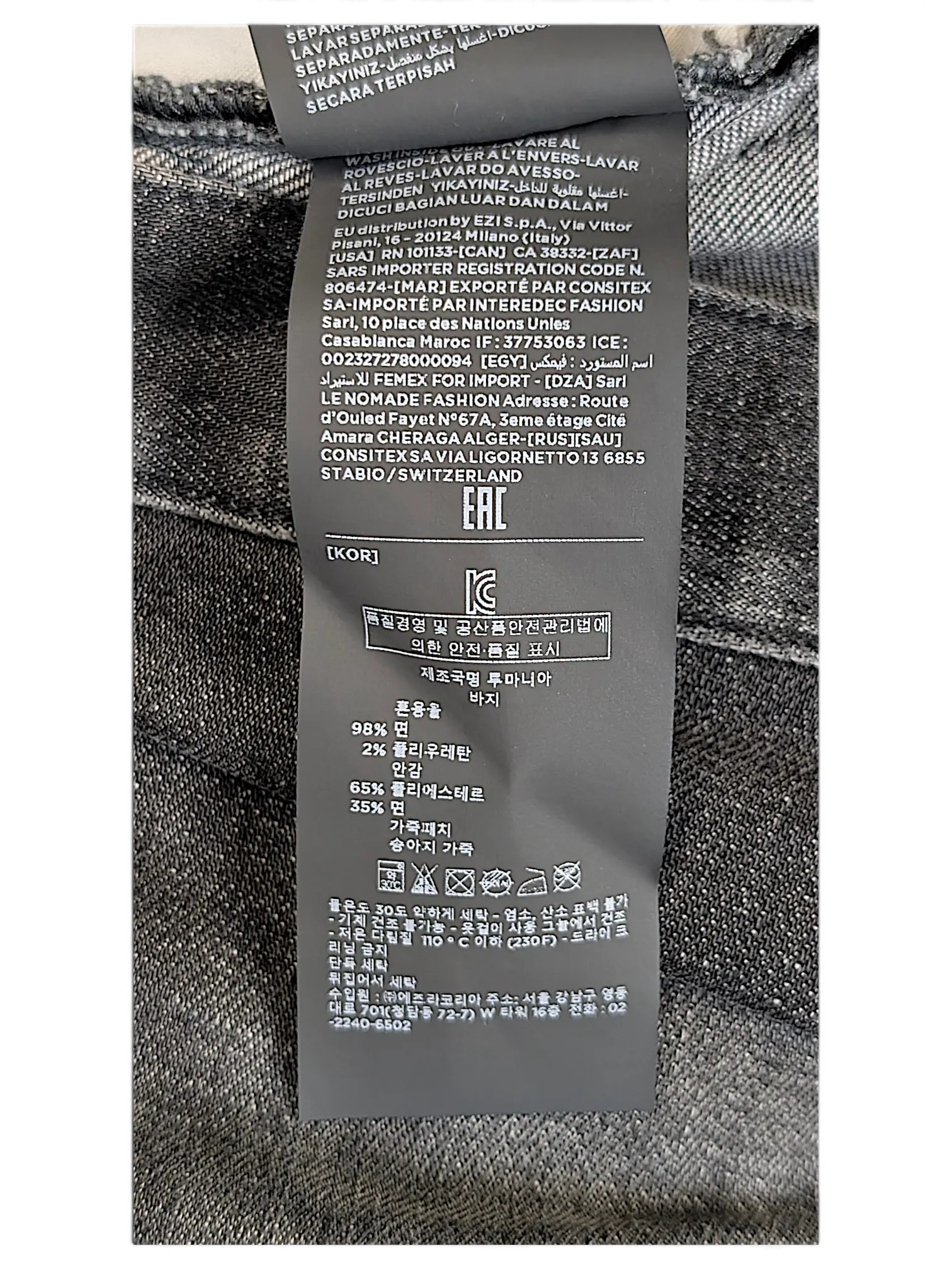 JAKE & IPI Zegna jeans interior care label with material composition and washing instructions in multiple languages