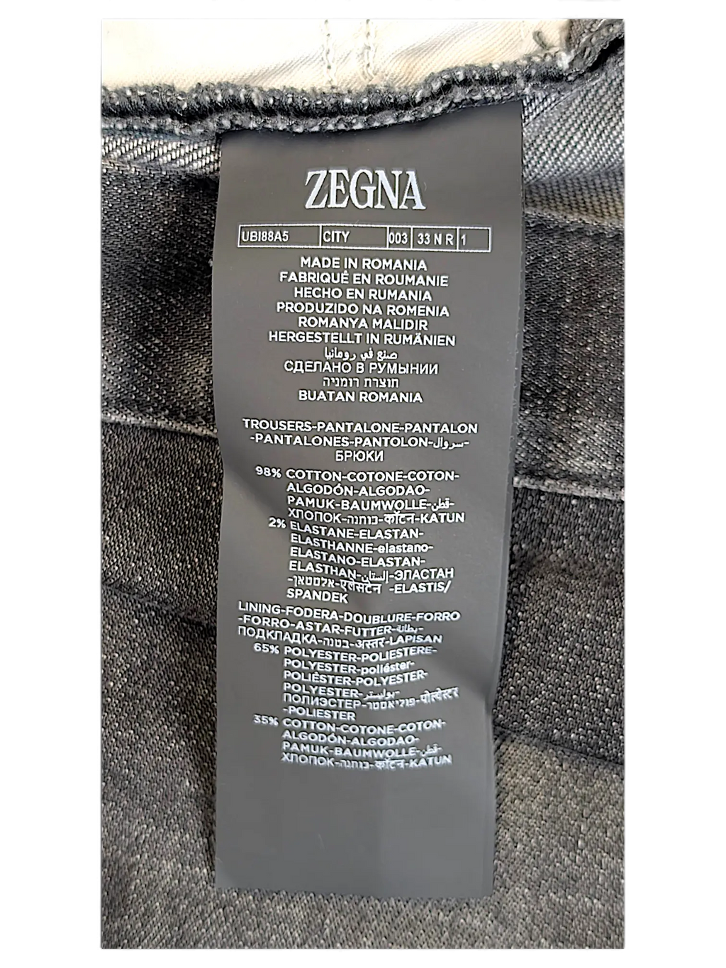 JAKE & IPI Zegna jeans care label showing material composition of 98 percent cotton and 2 percent elastane