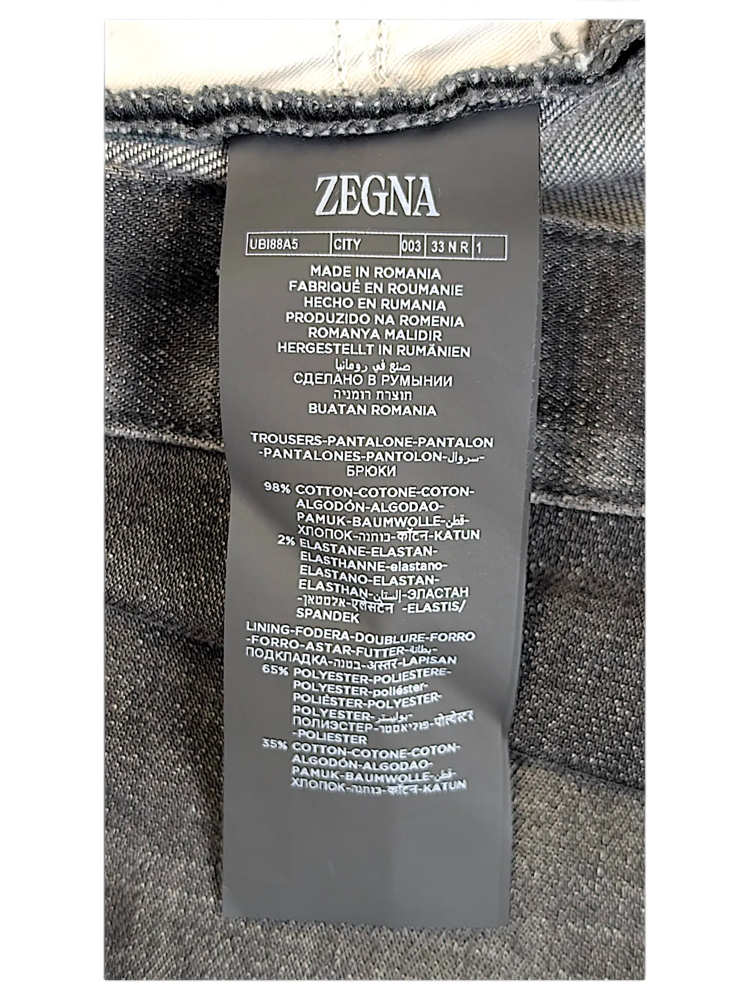 JAKE & IPI Zegna jeans care label showing material composition of 98 percent cotton and 2 percent elastane