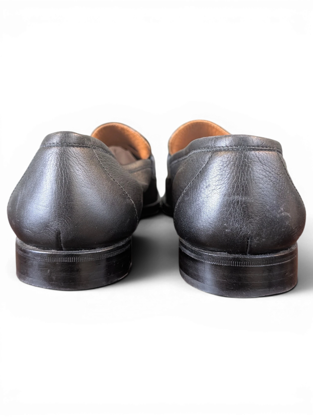JAKE & IPI Zenith black leather penny loafers showing the back heel view with stacked leather soles