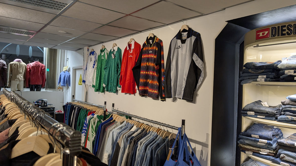 Football shirts on the wall and the Diesel denim cabinet at JAKE & IPI